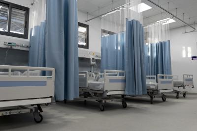 beds in a hospital with privacy curtains around them