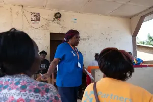 A woman presents in front of people 