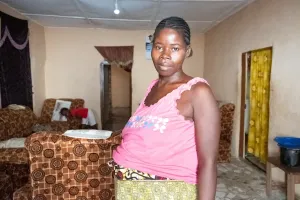 Pregnant woman standing in her living room