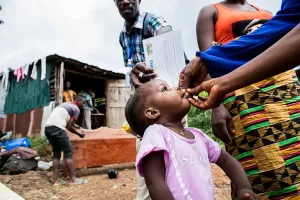 A child being given an oral cholera vaccine