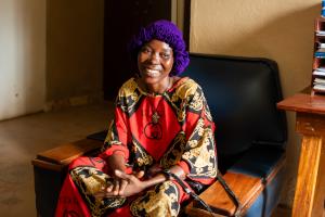 woman sitting on chair smiling into the camera