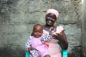 A woman sits with her baby