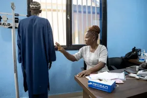 A nurse takes some measurements of a patient