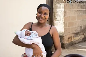A woman carrying a baby