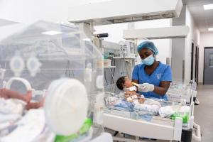 Nurse Danielle Jabati feeds a baby in the NICU.