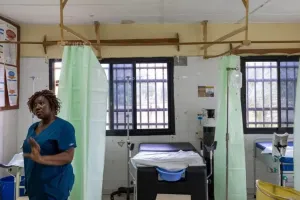 A nurse stands in a ward