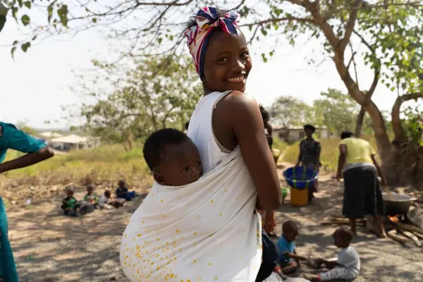 A woman carrying a child 