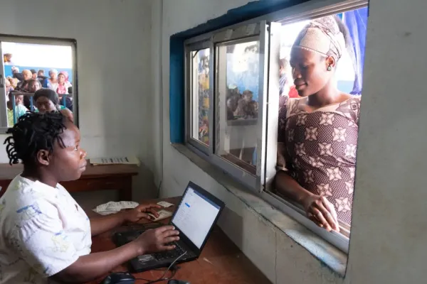 A woman registers at a front desk