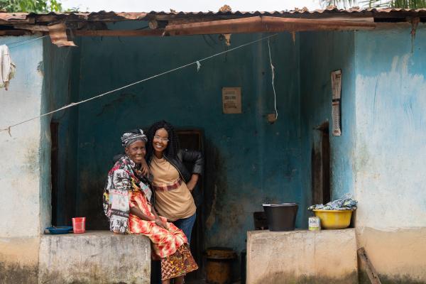 Community Health Worker Supervisor Ramatu Jalloh visits Fanta Kanawa, who recently began receiving visits, at her home in Koidu Town.