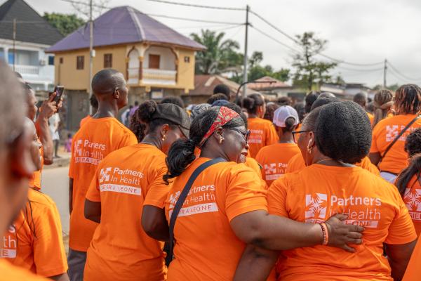 PIH Sierra Leone staff wearing orange PIH shirts