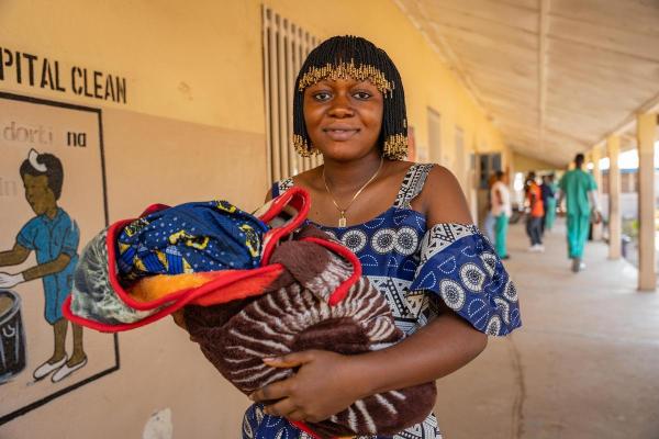 woman holds her newborn at hospital