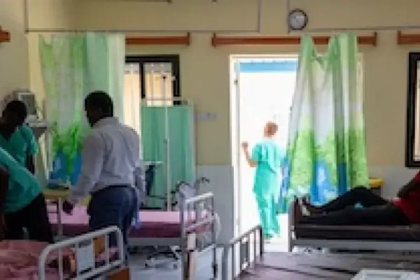 Patients and nurses in a hospital ward.