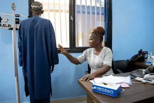 A nurse takes some measurements of a patient