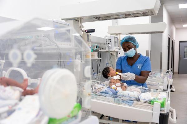 Nurse Danielle Jabati feeds a baby in the NICU.
