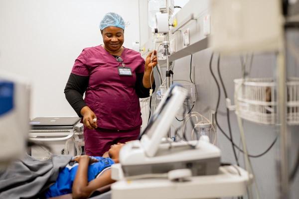 Nurse Moinya Lukulay tends to patient Augusta Allieu in the triage area
