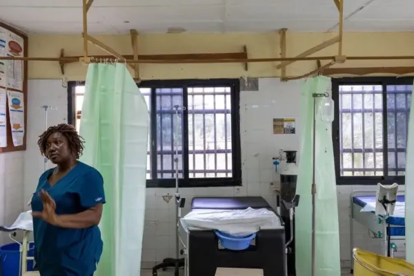 A nurse stands in a ward