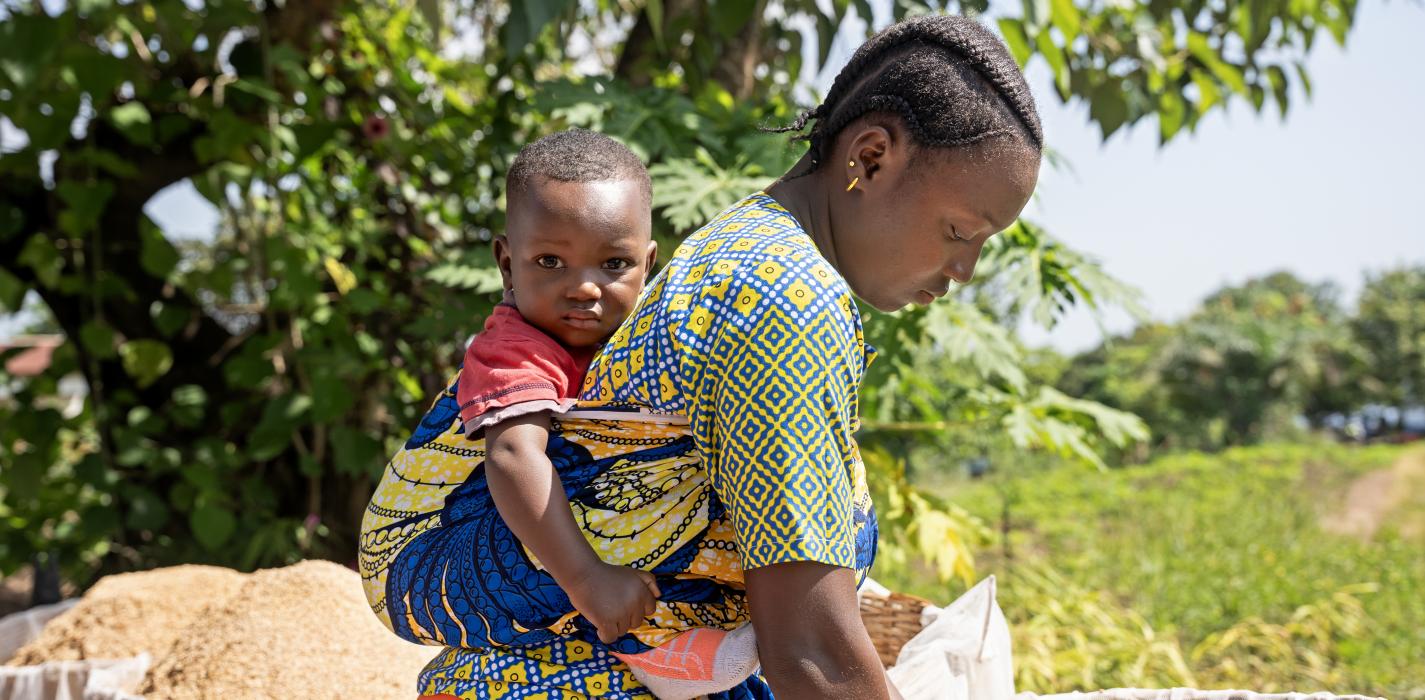 woman has her child on her back
