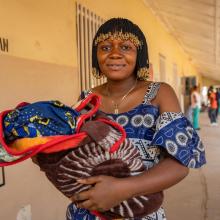 woman holds her newborn at hospital