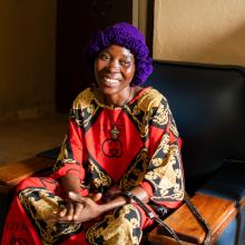 woman sitting on chair smiling into the camera
