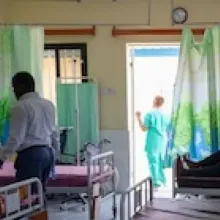 Patients and nurses in a hospital ward.