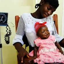 woman in hospital with baby on her lap