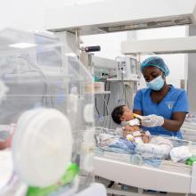 Nurse Danielle Jabati feeds a baby in the NICU.