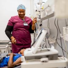 Nurse Moinya Lukulay tends to patient Augusta Allieu in the triage area