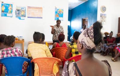 A woman listens to a talk on prenatal care.