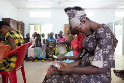 Woman looks at an electronic card she was given at a clinic