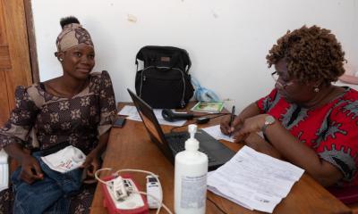 A woman talks to a clinician.