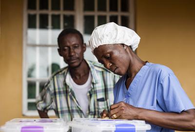 A nurse does some paperwork to discharge Mansaray