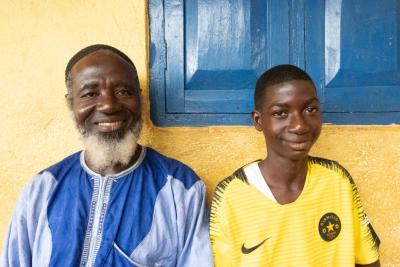 Mondeh and his father are sitting and smiling