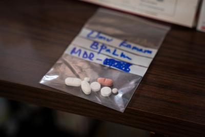 BPaLM tablets prepared for a patient in a small plastic bag on a table.
