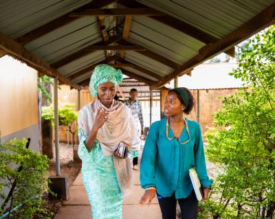 two women speaking while walking