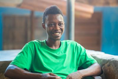 man sitting and smiling at the camera