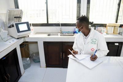 Osman Mansaray, takes notes as he learns to use the Auto Chemistry Analyzer GS100.