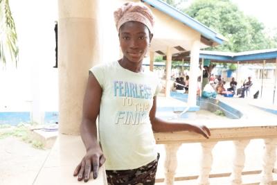 Margaret stands on a balcony at Koidu Government Hospital