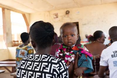 A woman carries a baby 