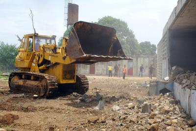 A bulldozer clears land on the Maternal Center of Excellence