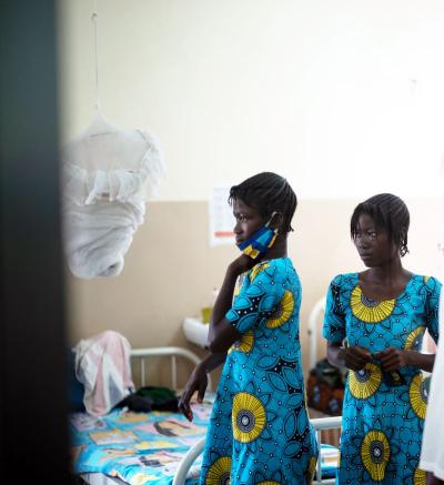Two girls (twin sisters) stand in a ward 