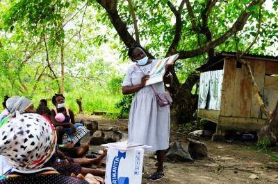 A woman teaches mothers about child nutrition
