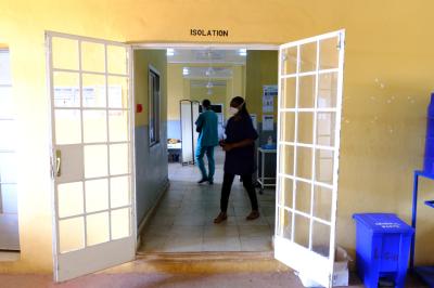 Two clinicians walk through the isolation unit at Lakka