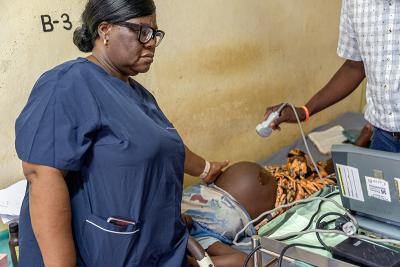 Clinicians examine a pregnant woman