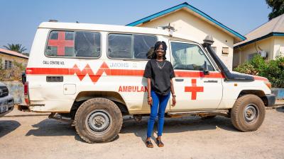 Joyce Senesie standing next to an ambulance outside