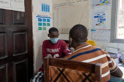 Edward Bendu (left) talks to a counselor at Lakka Government Hospital after being diagnosed with multidrug-resistant tuberculosis.