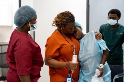 Isata Dumbuya comforts patient Fanta Jimmy