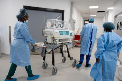 Staff transport a baby from operating theater to the NICU