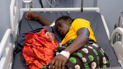 Sia Jimissa rests with her newborn son in the postoperative ward at the MCOE