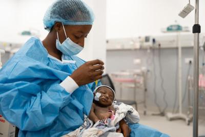 Phebian Baningo feeds her daughter by nasogastric tube in the NICU