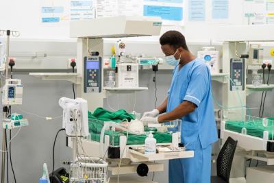 Benjamin Moripeh tends to a baby the NICU